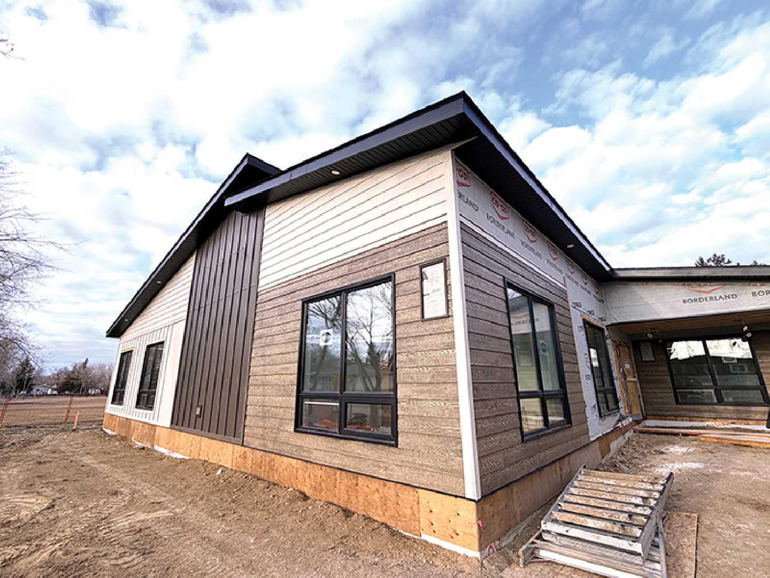 The exterior of the building with work still progressing on the siding.